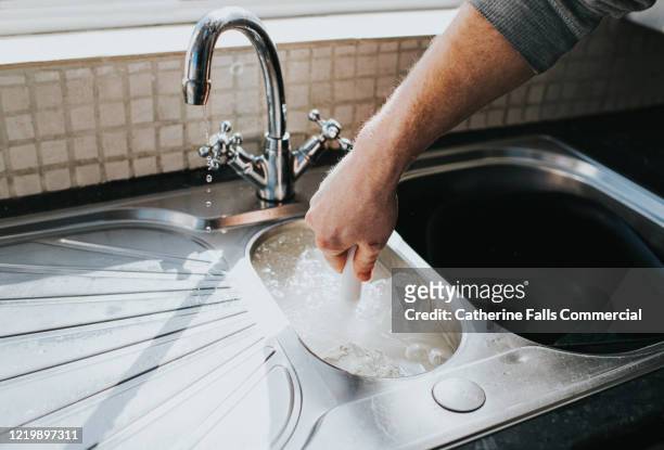 plunging a sink - clogs - fotografias e filmes do acervo