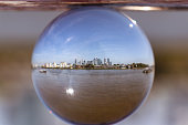 Famous modern city - London in small glass ball with Thames river. Whole huge city in 10 centimetre big ball. View on Thames river, Canary wharf, Isle of dogs, Millwall and more