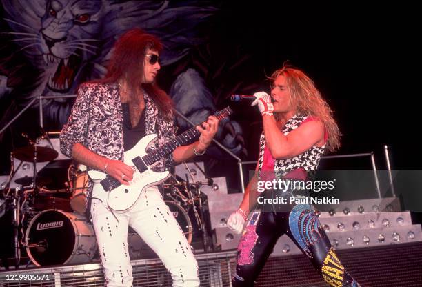 Rock musicians Vito Bratta and Mike Tramp, both of the group White Lion, perform onstage at the Alpine Valley Music Theater, East Troy, Wisconsin,...