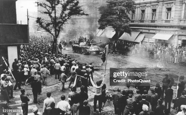 Unarmed citizens jeer invading Soviet military forces, shouting, "Fascists!" and "Russians go home!", Prague, Czechoslovakia, August 1968.