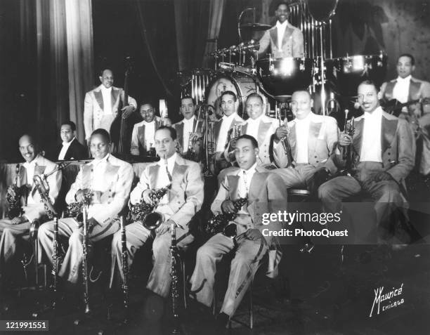 Duke Ellington's Original Big Band poses in Chicago, IL, 1930. Ellington, in dark jacket, sits at left at piano.