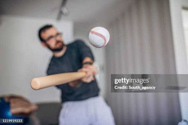 man hitting baseball ball at home - sports bat stock pictures, royalty-free photos & images