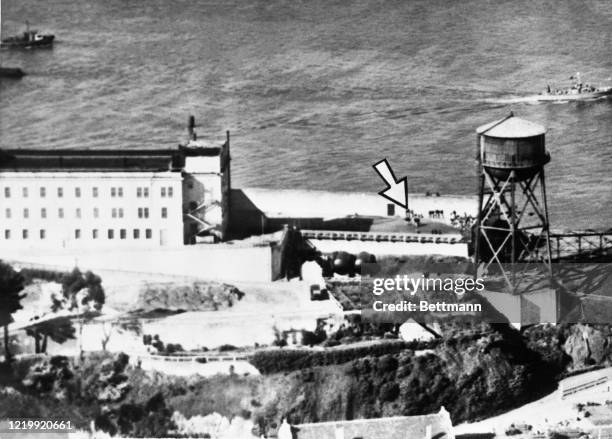 This aerial photo shows groups of convicts as they are herded in the compound of Alcatraz Federal Penitentiary. With the initial flare-up, which...