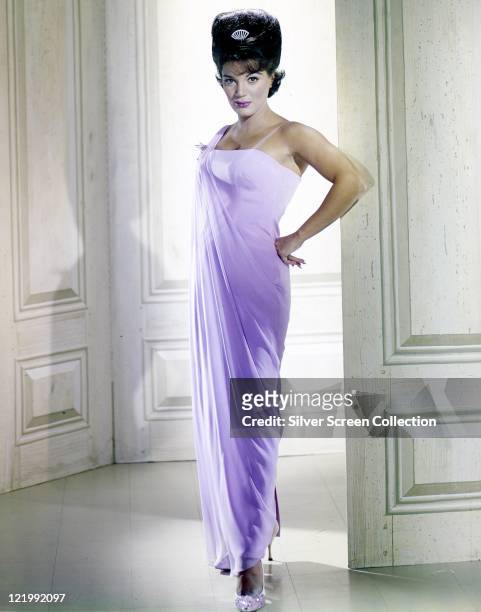 Full-length shot of Connie Francis, US singer, wearing a long lilac dress with her hair in a beehive hairstyle, circa 1965.