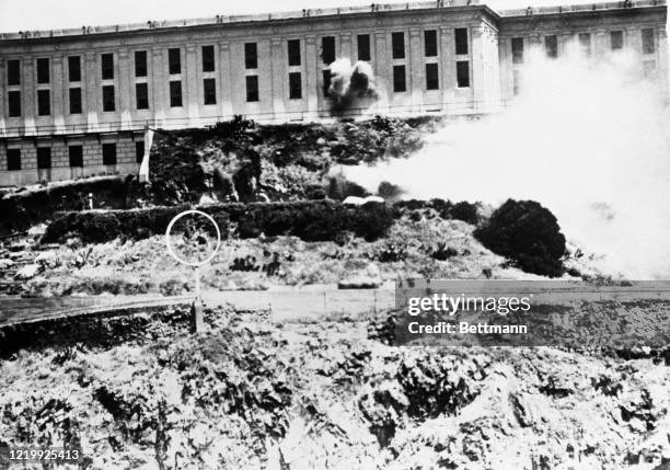 As Alcatraz prison's bloody state of siege continued unabated today, the Marine Corps joined in efforts to quell the uprising. Pictured in foreground...