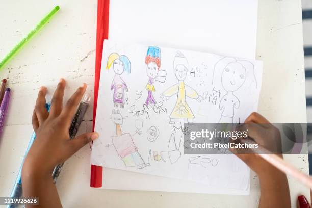 daughter of lesbian couple draws family picture - kid hand raised stock pictures, royalty-free photos & images