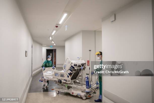 Medical staff move a patient recovering from the COVID-19 virus from the COVID-19 dedicated ICU to the in-patient ward at the Acibadem Altunizade...