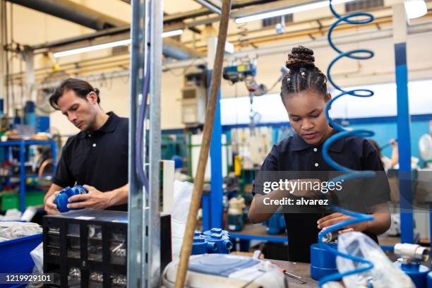 factory employees working on assembly line - production line imagens e fotografias de stock