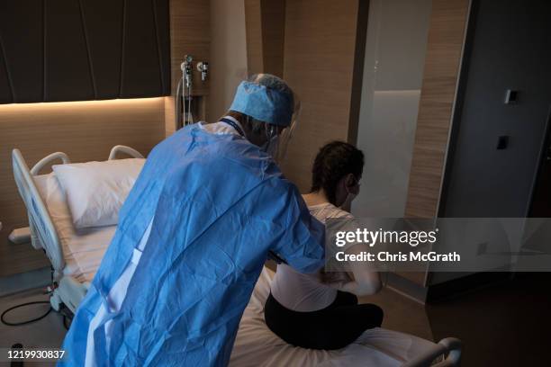 Medical worker checks on a patient recovering from the COVID-19 virus in the COVID-19 in-patient ward at the Acibadem Altunizade Hospital on April...