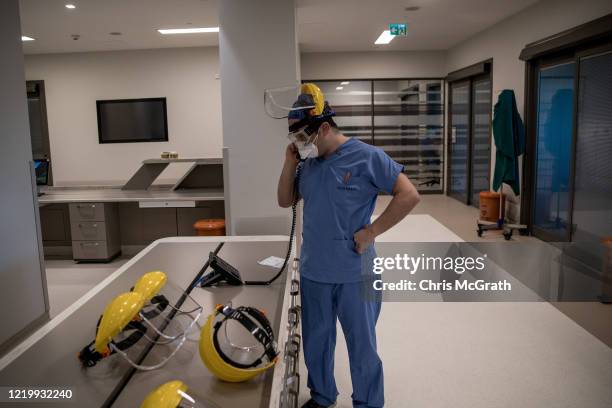 Medical worker talks on the phone inside the COVID-19 dedicated ICU at the Acibadem Altunizade Hospital on April 16, 2020 in Istanbul, Turkey. Since...