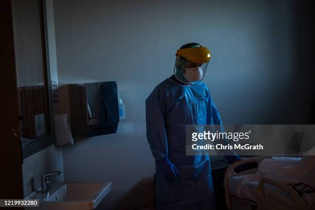 Medical staff attend a patient infected with the COVID-19 virus in the COVID-19 dedicated ICU at the Acibadem Altunizade Hospital on April 16, 2020...