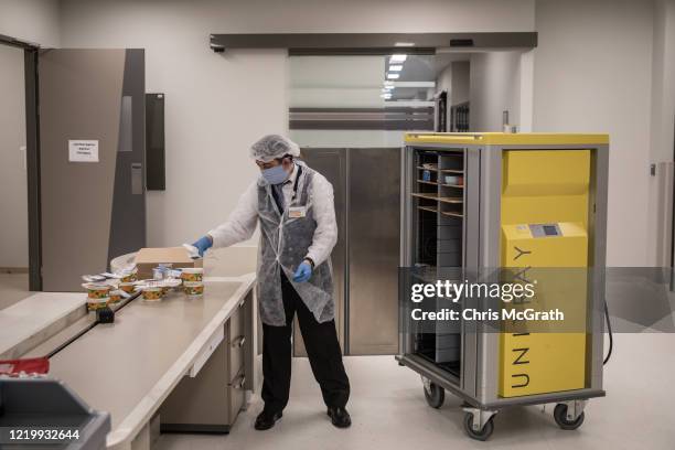 An employee delivers boxed lunches to the medical staff working inside the COVID-19 dedicated ICU at the Acibadem Altunizade Hospital on April 16,...