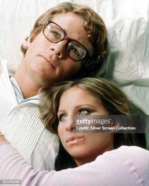 Ryan O'Neal, US actor, wearing spectacles with tortoise shell frames, and Barbra Streisand, US actress and singer, with a publicity still issued for...