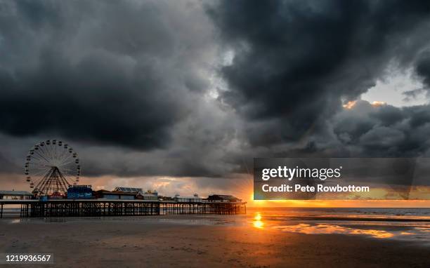 sunset in a storm - blackpool stock pictures, royalty-free photos & images