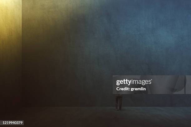 lonely woman standing in empty concrete room - woman prison stock pictures, royalty-free photos & images