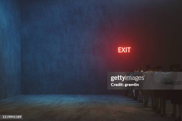 tired people waiting in front of exit sign - miss light stock pictures, royalty-free photos & images