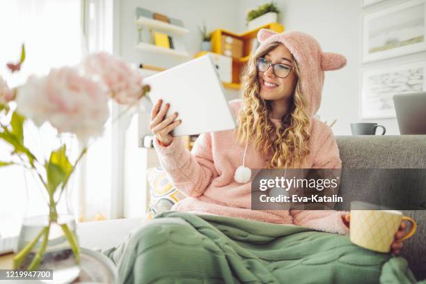 young woman at home - bear suit stock pictures, royalty-free photos & images