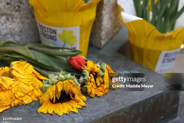 Flowers placed at the memorial to the victims of the Boston Marathon bombings near the Boston Marathon finish line on April 20, 2020 in Boston,...