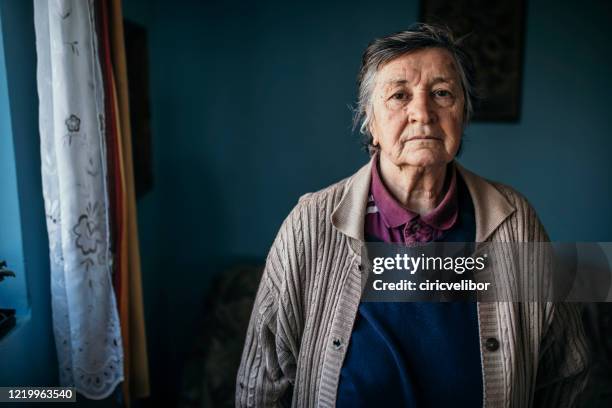 portrait of senior woman looking at camera - critical illness stock pictures, royalty-free photos & images