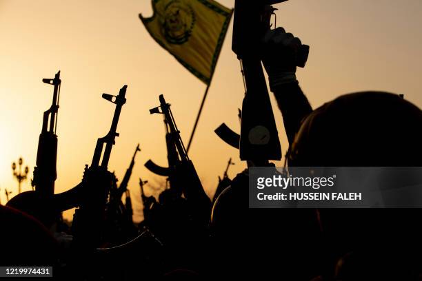 Members of the Hashed al-Shaabi paramilitary force take part in a military parade in the southern Iraqi city of Basra on June 14 marking the sixth...