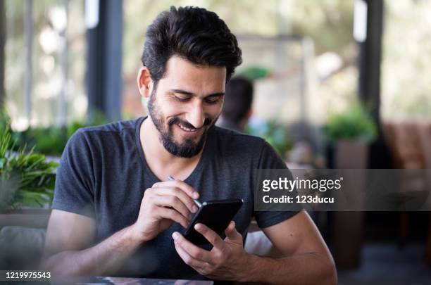 indian man working at cafe - turkey middle east stock pictures, royalty-free photos & images