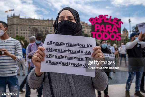 Protester holds a placard calling for the mass regularization of the national identity during the demonstration. Convened by the Union of Home and...