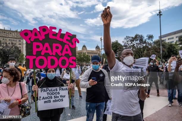 Protesters hold placards during the demonstration. Convened by the Union of Home and Care Workers, a hundred undocumented people and activists have...