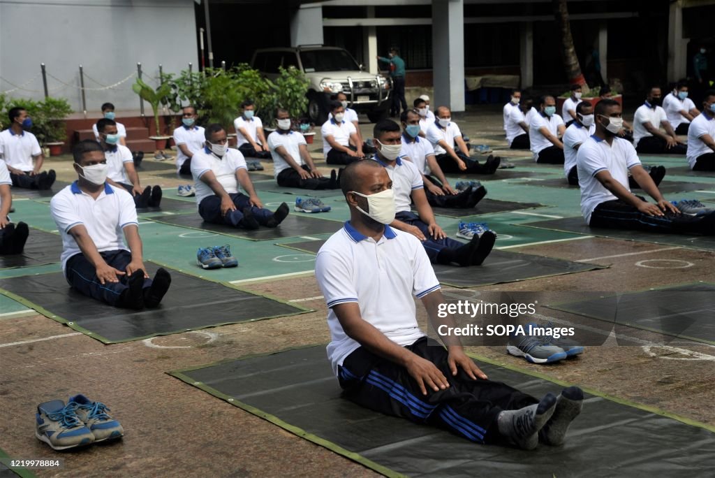 Members of the Bangladesh police wearing face masks attend a...