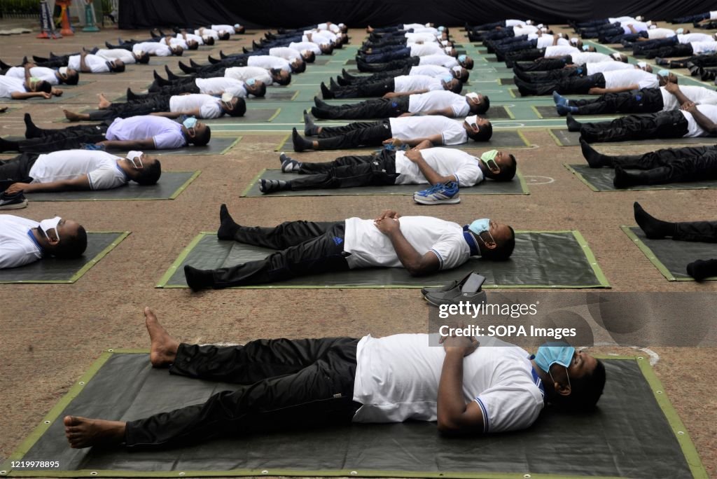 Members of the Bangladesh police wearing face masks attend a...