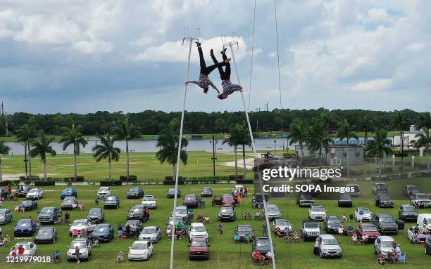 Erendira Wallenda and Alec Bryant perform on the sway poles at Nik Wallenda's Daredevil Rally, billed as the world's first drive-in stunt show, at...