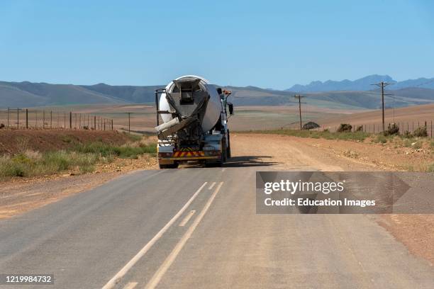 Caledon, Western Cape, South Africa, Truck travelling from a tarmac to a dirt road in countryside close to Caledon, South Africa.