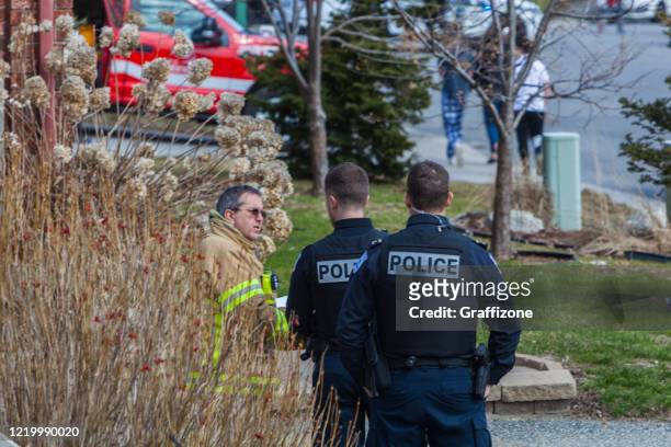 firefighter and two police officers at the time of the coronavirus - gatineau stock pictures, royalty-free photos & images