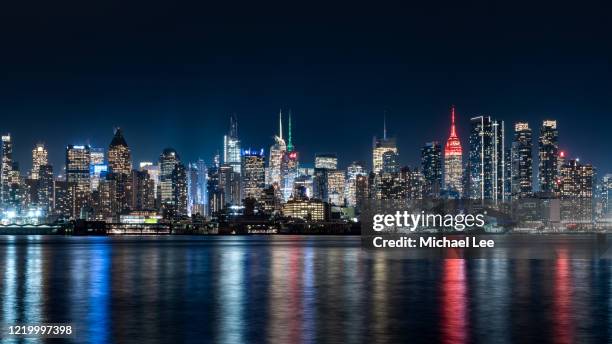 midtown manhattan night skyline view - new york - empire state building red stock pictures, royalty-free photos & images