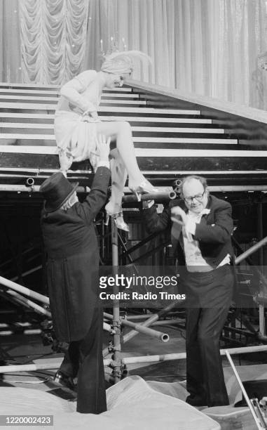 Comedians Eric Morecambe and Ernie Wise filming a performance with actress Penelope Keith for the Christmas special episode of the BBC television...