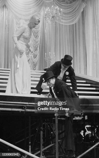 Comedians Eric Morecambe and Ernie Wise filming a performance with actress Penelope Keith for the Christmas special episode of the BBC television...