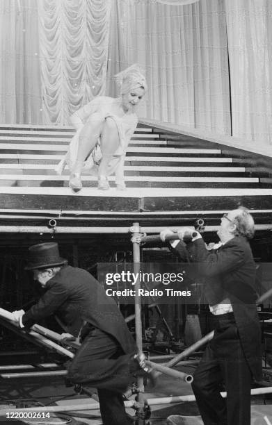 Comedians Eric Morecambe and Ernie Wise filming a performance with actress Penelope Keith for the Christmas special episode of the BBC television...