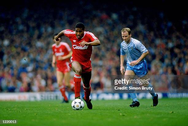 John Barnes of Liverpool gets away from David Speedie of Coventry City during the Division One match played at Anfield in Liverpool, England. The...