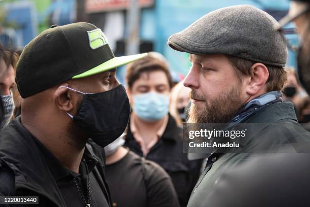 Man carrying a brick is confronted by protesters inside the âCapitol Hill Organized Protestâ formerly known as the âCapitol Hill Autonomous Zoneâ in...