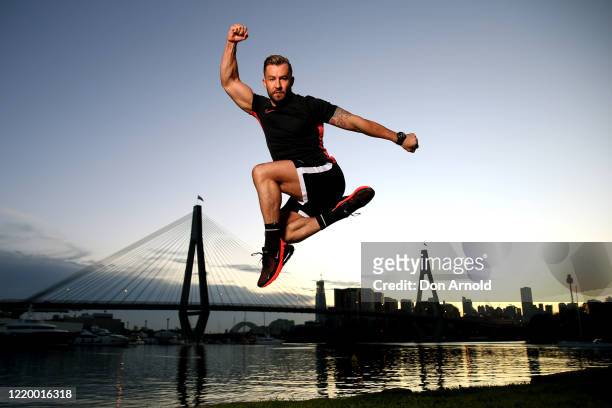 Dancer, instructor and musical theatre performer Heath Keating performs a dance manoeuvre on the shoreline at Blackwattle Bay on April 21, 2020 in...