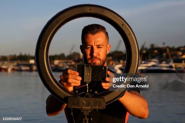 Dancer, instructor and musical theatre performer Heath Keating records a dance/fitness routine for his social media followers on the shoreline at...