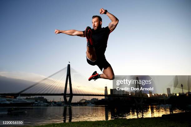 Dancer, instructor and musical theatre performer Heath Keating performs a dance manoeuvre on the shoreline at Blackwattle Bay on April 21, 2020 in...