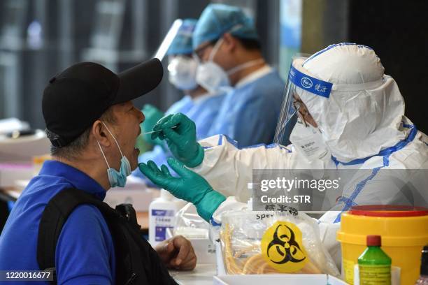 Man, who visited Beijing recently, is tested for the COVID-19 coronavirus in Nanjing in China's eastern Jiangsu province on June 15, 2020. - China's...