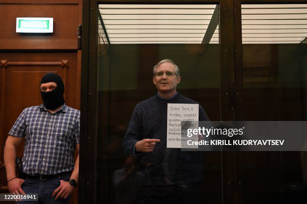 Paul Whelan, a former US marine accused of espionage and arrested in Russia in December 2018, stands inside a defendants' cage as he waits to hear...