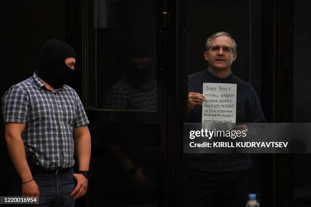 Paul Whelan, a former US marine accused of espionage and arrested in Russia in December 2018, stands inside a defendants' cage as he waits to hear...