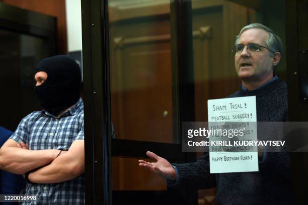 Paul Whelan, a former US marine accused of espionage and arrested in Russia in December 2018, stands inside a defendants' cage as he waits to hear...