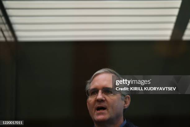 Paul Whelan, a former US marine accused of espionage and arrested in Russia in December 2018, stands inside a defendants' cage as he waits to hear...