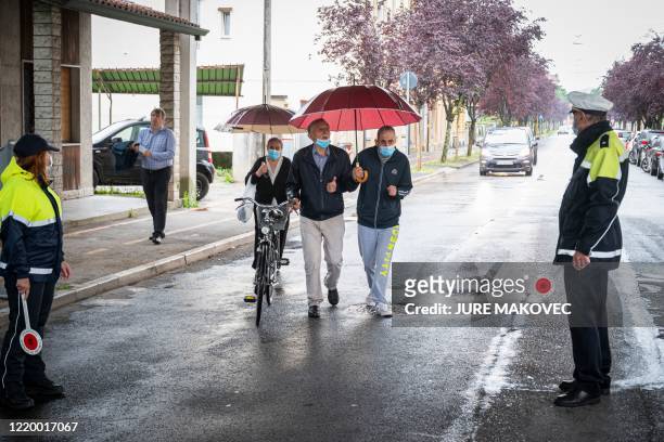 Italian police officers stand guard as people prepare to cross the border in Nova Gorica, Slovenia on June 15 as the border between Slovenia and...