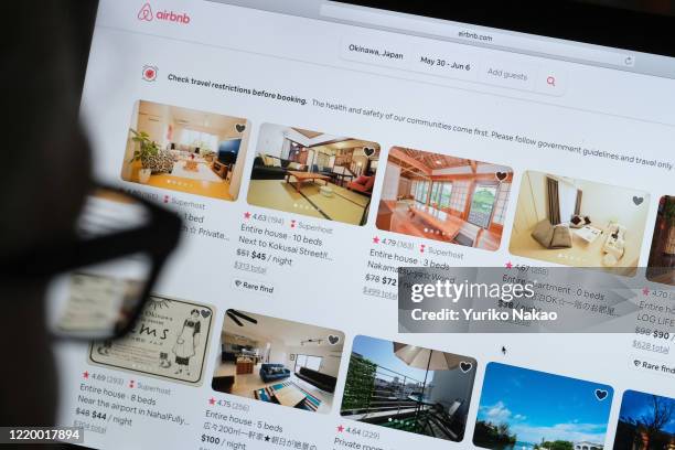 In this photo illustration, a man looks at the website of Airbnb on April 20, 2020 in Katwijk, Netherlands.