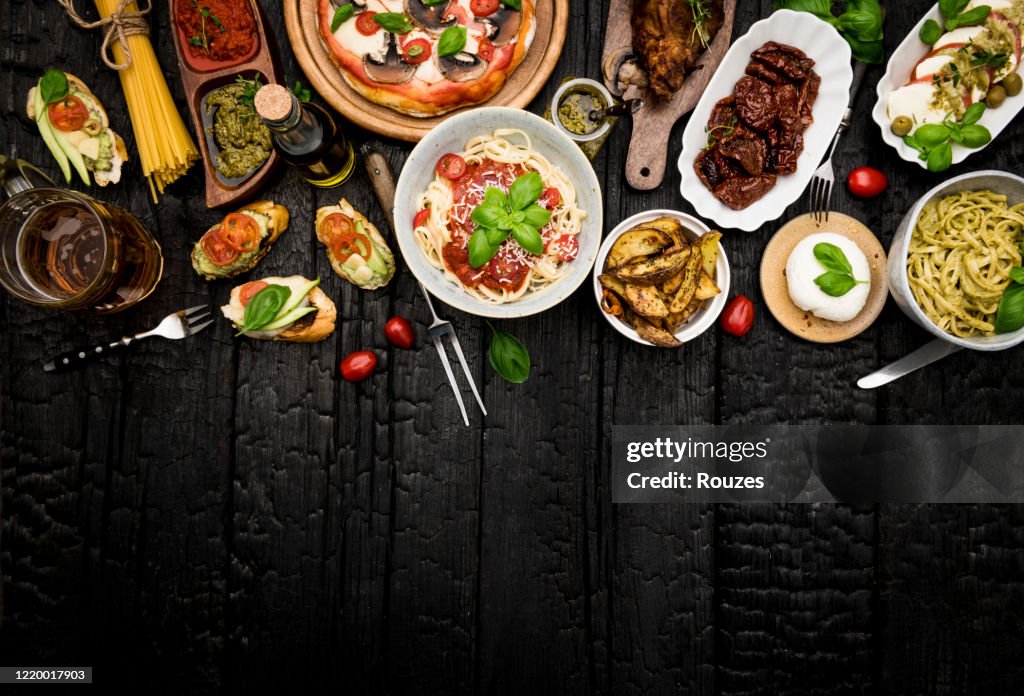 Different food cooked on a dark wooden background
