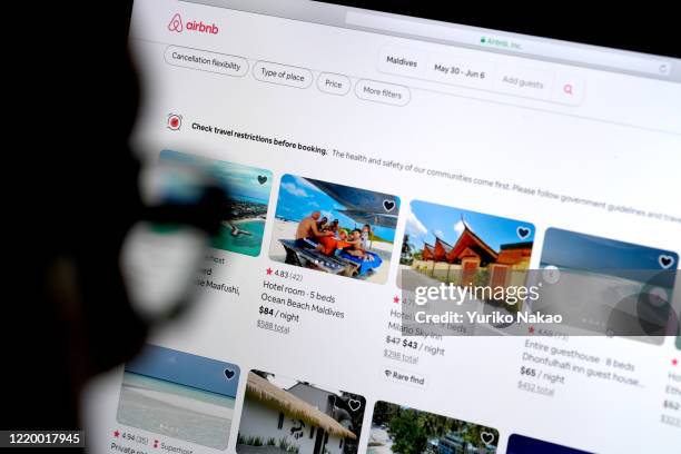 In this photo illustration, a man looks at the website of Airbnb on April 20, 2020 in Katwijk, Netherlands.